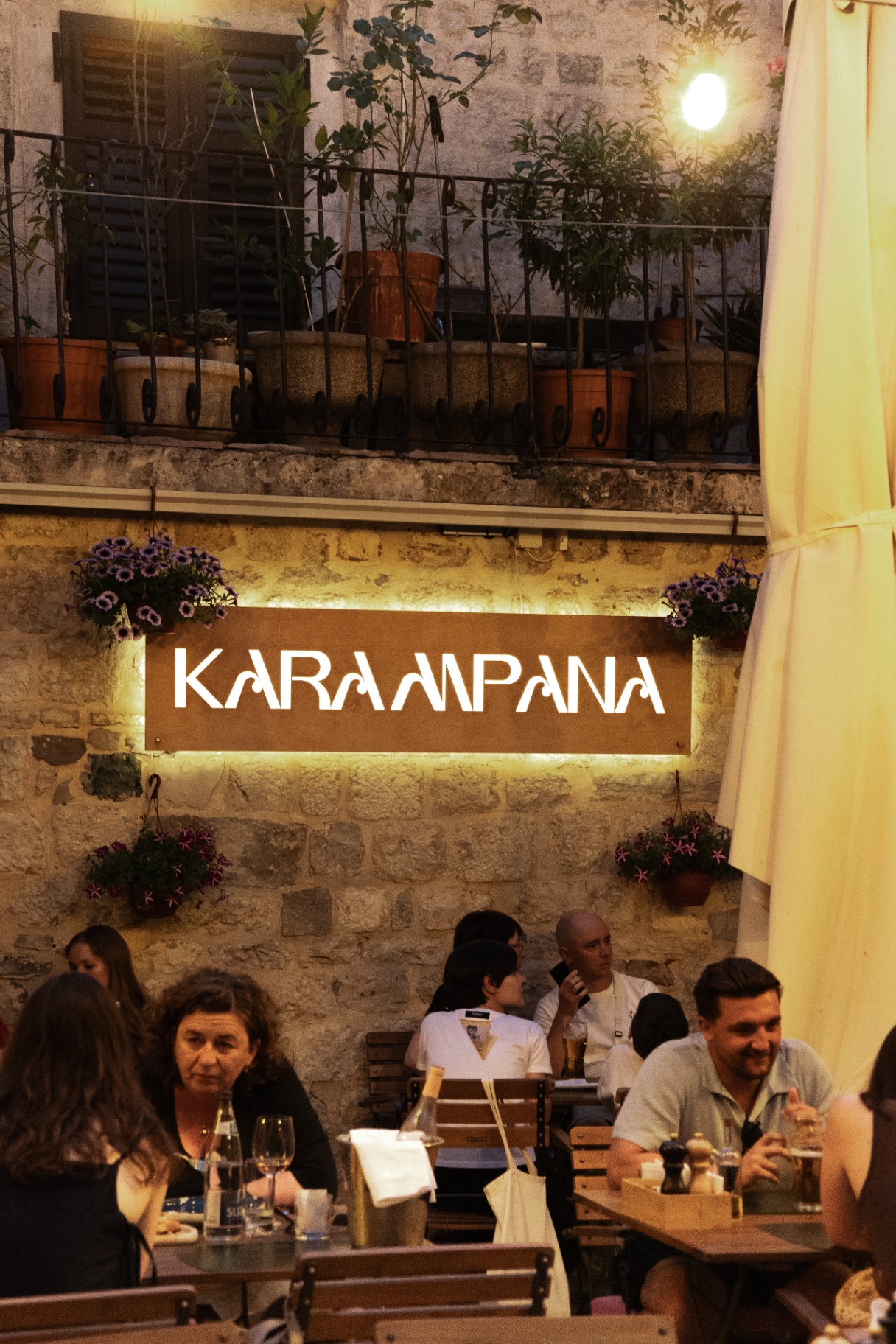 Illuminated Karampana sign at dusk
