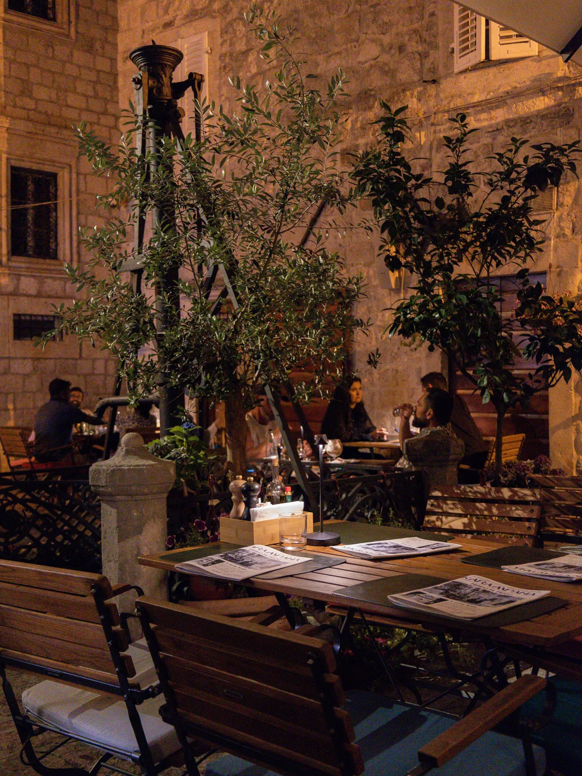 Karampana terrace on a Kotor Old Town square at dusk
